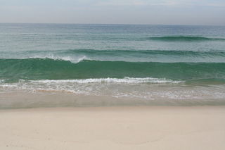 1200px-Gentle_waves_come_in_at_a_sandy_beach.jpg